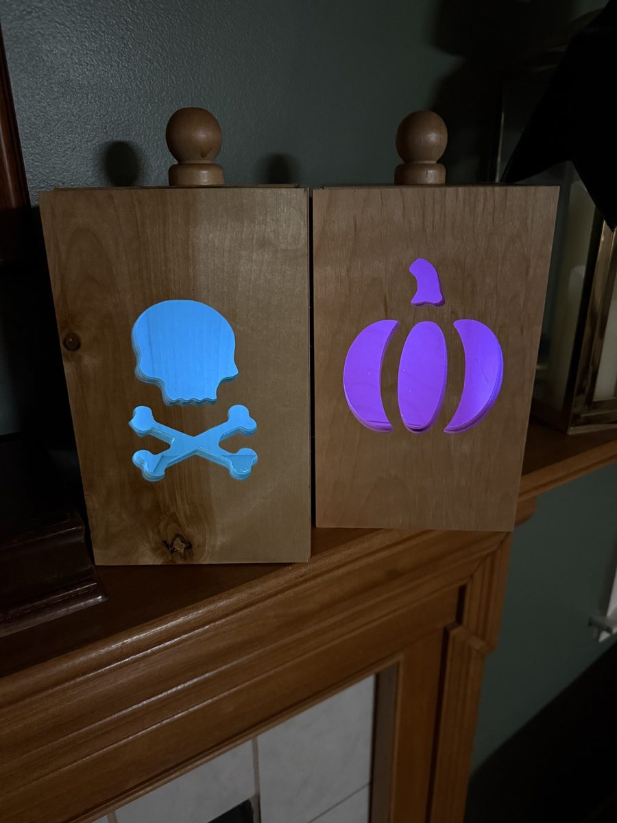 Skull n Bones and Pumpkin luminaries glowing blue and purple