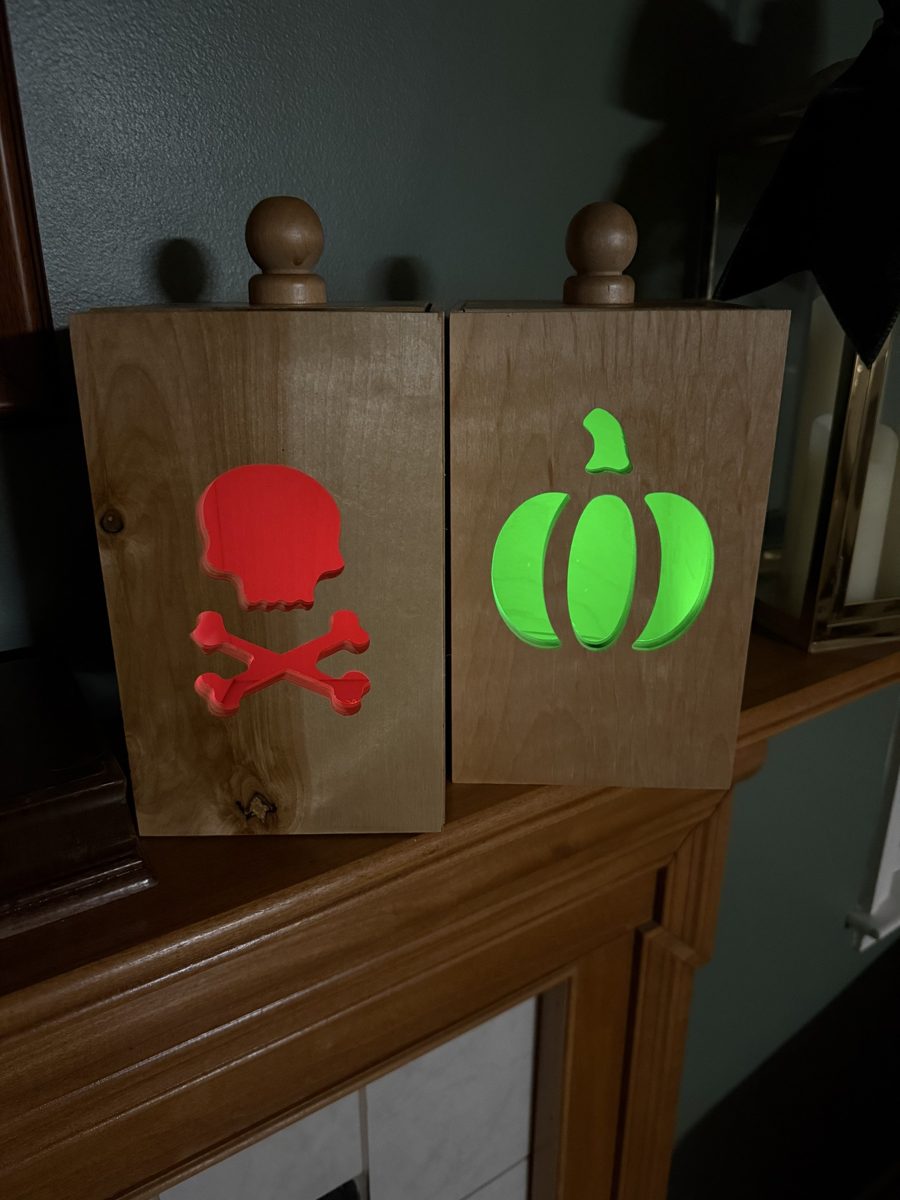 Two luminaries glowing, skull and pumpkin